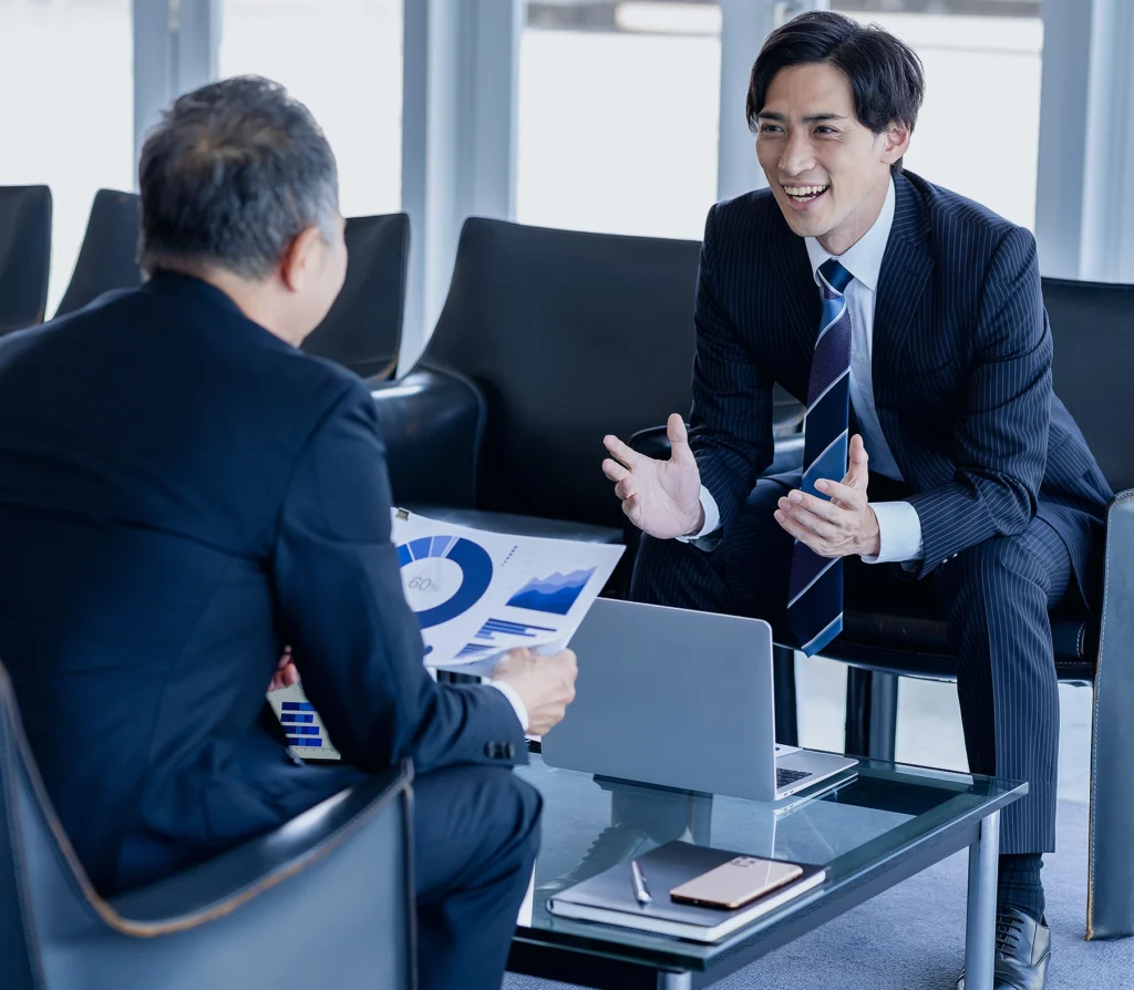 Business professionals discussing growth strategies in a meeting for ongoing support and expansion at Japan trade expos, showcasing WeLink's comprehensive consulting services.